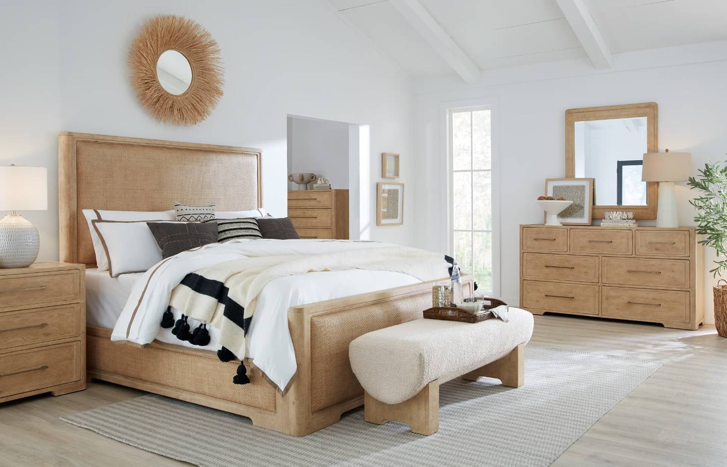 Woven panel bed with matching dresser, mirror, and nightstands in a light oak bedroom set at Gavigan's in Maryland