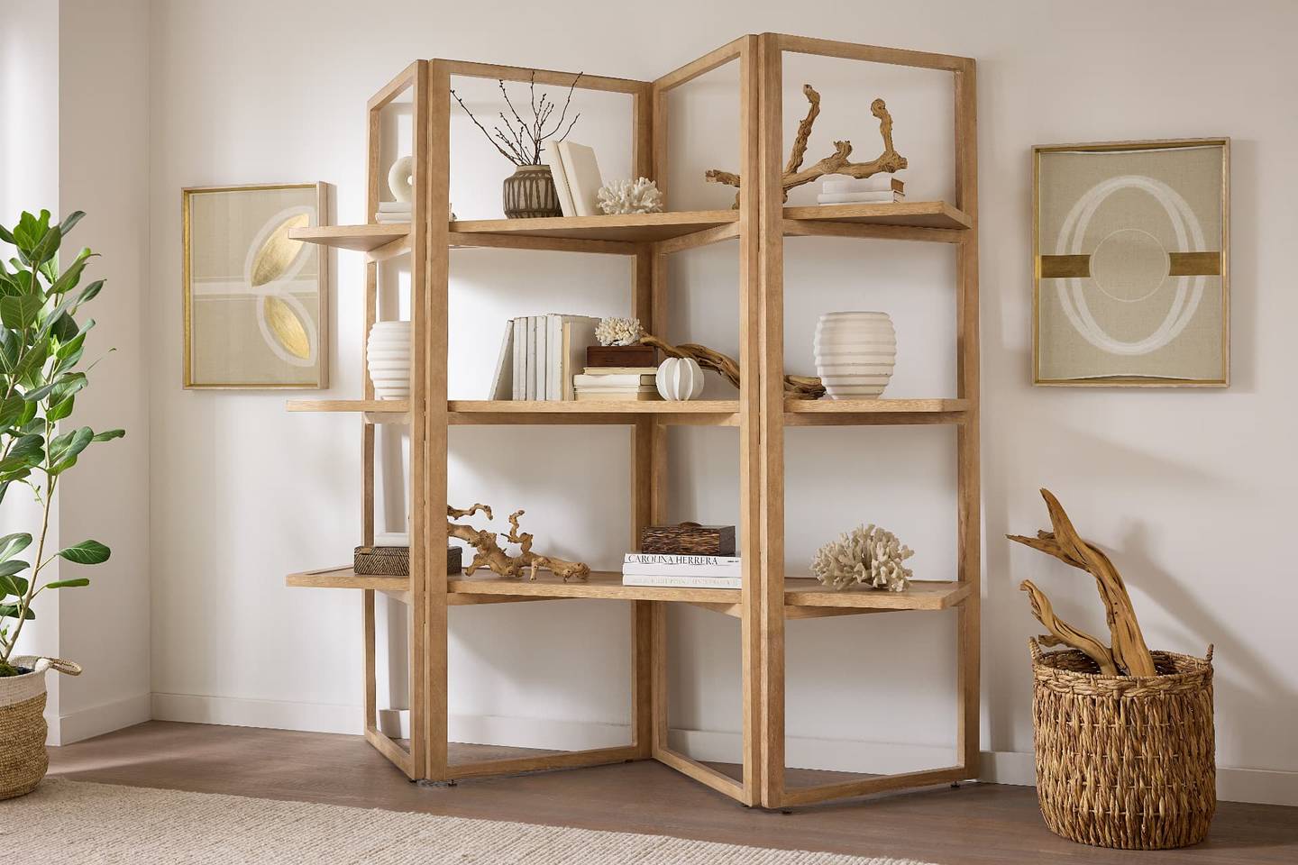Open oak etagere bookcase styled with books and decor in a home office corner