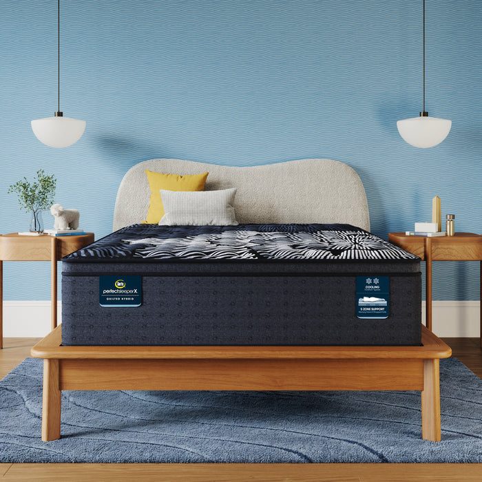 Serta Perfect Sleeper X Max Firm Pillow Top quilted hybrid mattress styled in a bedroom